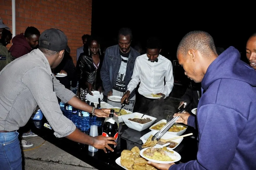 Members sharing food at an evening gathering