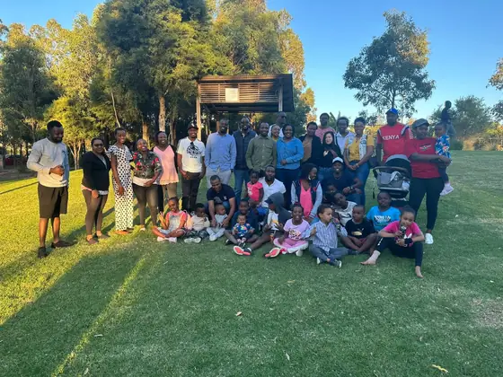 UKACA families gathered on the grass at a picnic